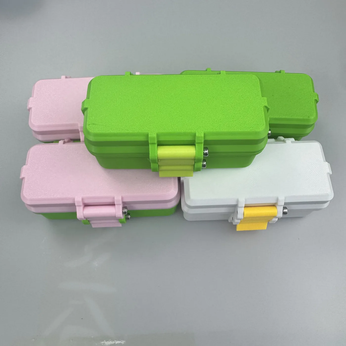 Multiple 10 slot vial cases stacked in green pink and white